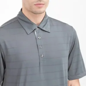 A man wearing the Elevate polo on a golf course, showcasing the professional performance and freedom of movement.