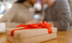 Anniversary Gifts Photo album opened to pages showing wedding and family moments, with small anecdotes written beside each photo