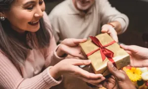 Engraved cufflinks with initials, displayed alongside a folded dress shirt and tie