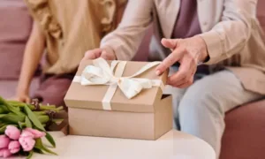 Personalized phone lanyard with initials, draped over a smartphone on a wooden desk